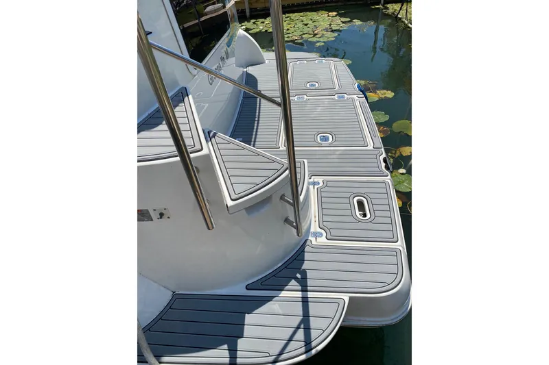Slide: The Image of 2005 Cruisers Yachts 405 Express Motoryacht swim platform with sleek gray decking. - 8