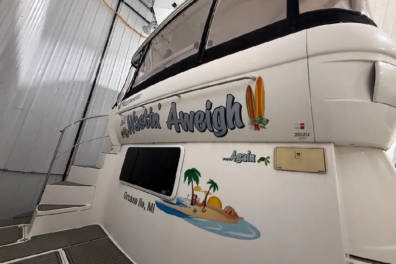 Slide: The Image of 2005 Cruisers Yachts 405 Express Motoryacht in storage, featuring custom graphics and name. - 9