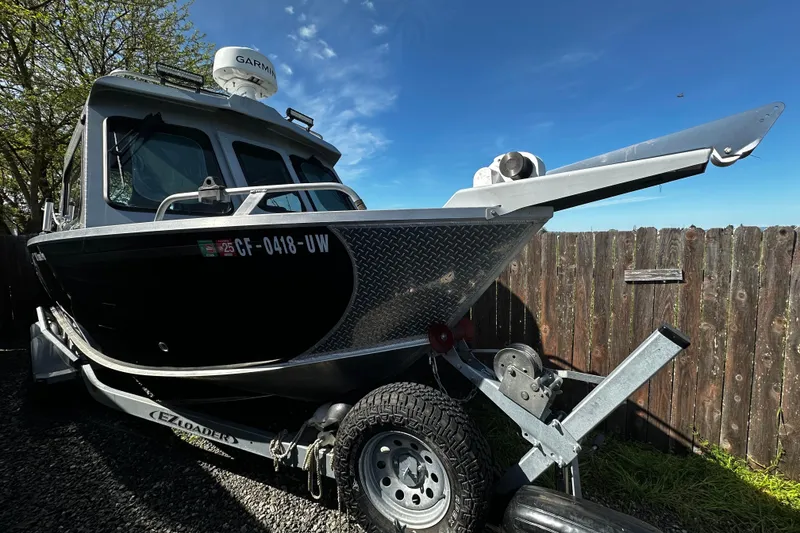 Slide: The Image of 2022 Hewescraft 220 Ocean Pro ET Hardtop boat on trailer, parked outdoors. - 1