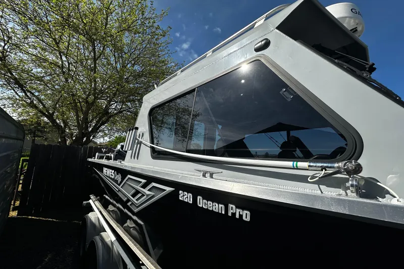 Slide: The Image of 2022 Hewescraft 220 Ocean Pro ET Hardtop boat under a clear blue sky. - 13