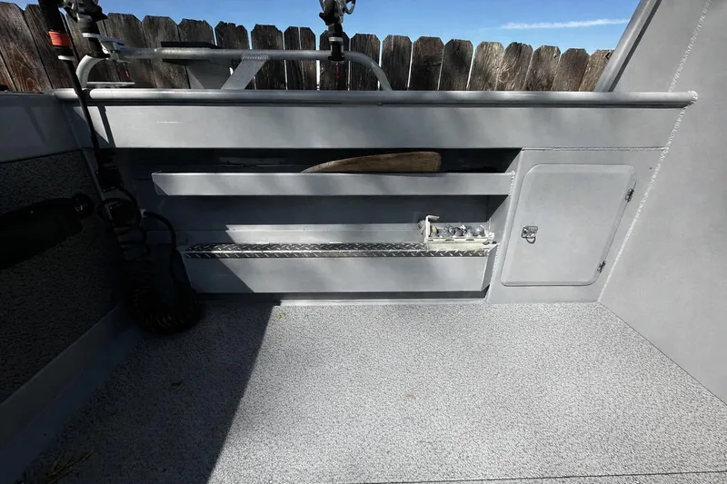 Slide: The Image of Interior of 2022 Hewescraft 220 Ocean Pro ET Hardtop boat, featuring storage compartments. - 18