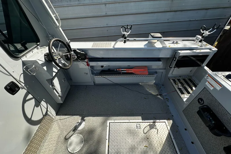 Slide: The Image of 2022 Hewescraft 220 Ocean Pro ET Hardtop interior with steering wheel and storage compartments. - 19