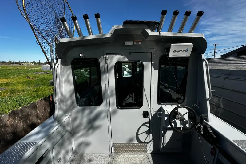 Slide: The Image of 2022 Hewescraft 220 Ocean Pro ET Hardtop boat with Garmin equipment, docked outdoors. - 20