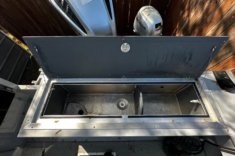 Slide: The Image of Open storage compartment on a 2022 Hewescraft 220 Ocean Pro ET Hardtop boat. - 21