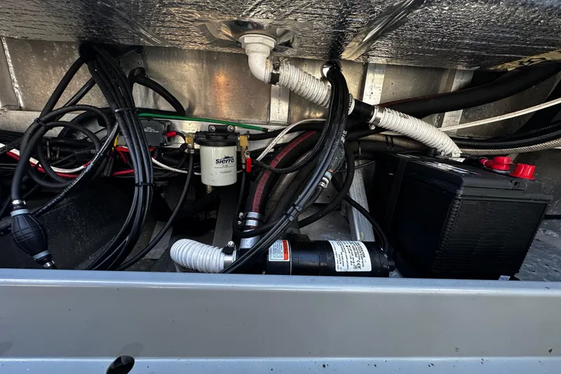 Slide: The Image of Electrical and plumbing components inside a 2022 Hewescraft 220 Ocean Pro ET Hardtop boat. - 22