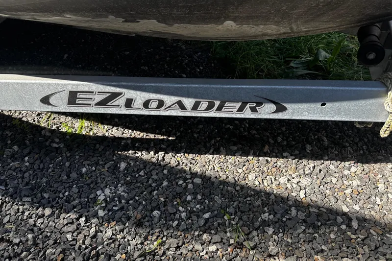 Slide: The Image of EZ Loader trailer under a 2022 Hewescraft 220 Ocean Pro ET Hardtop boat. - 25