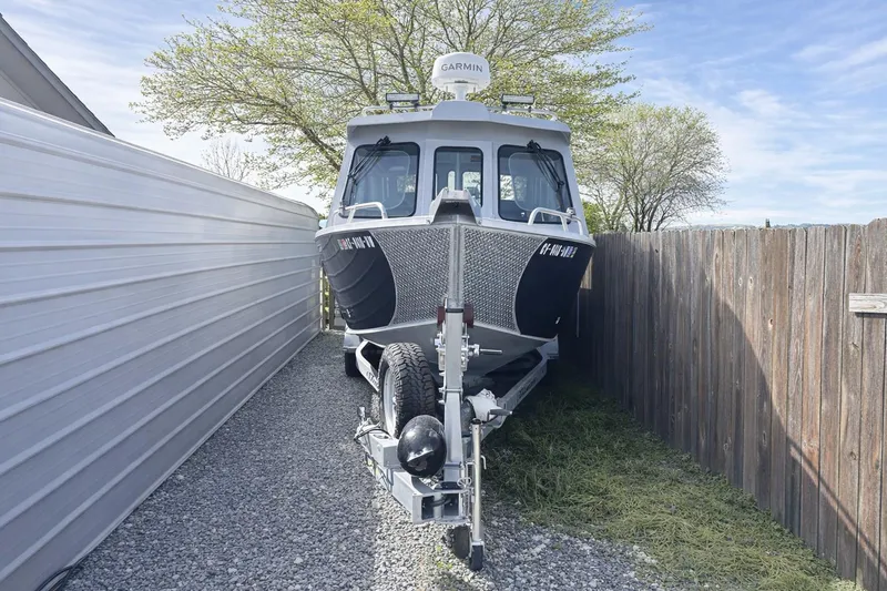 Slide: The Image of 2022 Hewescraft 220 Ocean Pro ET Hardtop boat parked on gravel beside a fence. - 4