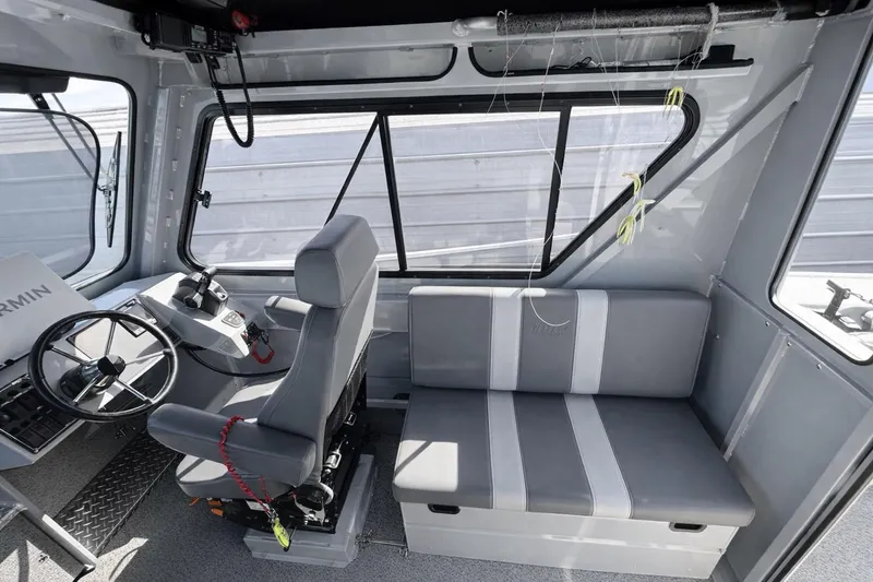 Slide: The Image of Interior of 2022 Hewescraft 220 Ocean Pro ET Hardtop, featuring steering wheel and seating. - 8
