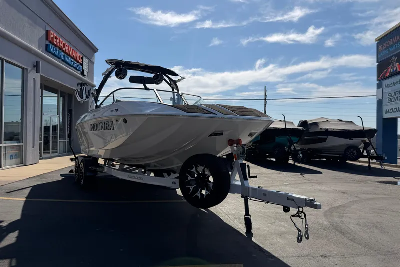 Slide: The Image of 2025 Moomba Makai boat on trailer at Performance Marine Watersports dealership. - 11