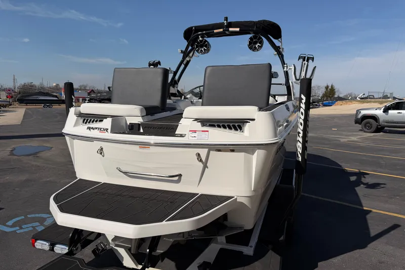 Slide: The Image of 2025 Moomba Makai boat with Raptor engine, parked in a lot under clear skies. - 14