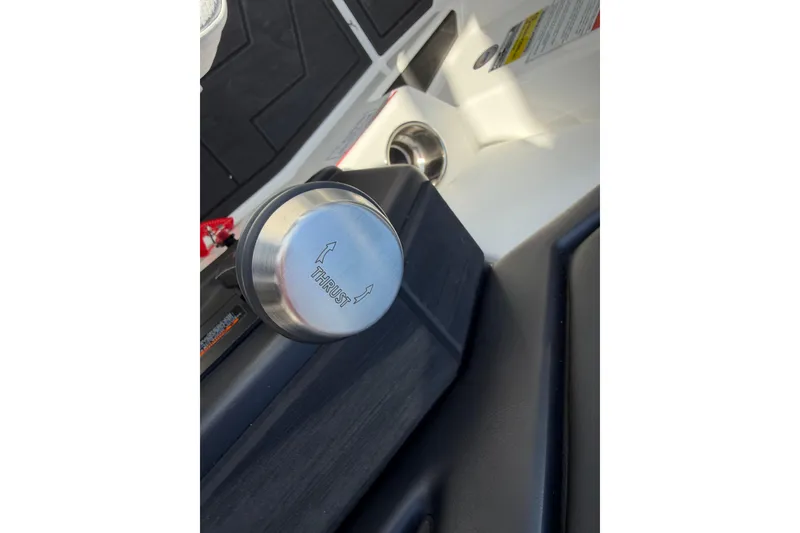Slide: The Image of Close-up of 2025 Moomba Makai boat throttle control knob labeled "Thrust." - 20