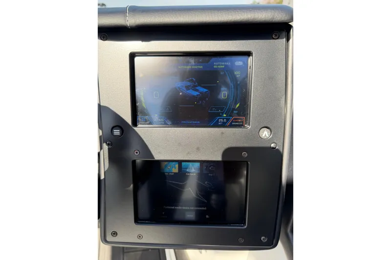 Slide: The Image of 2025 Moomba Makai dashboard with dual touchscreen displays and navigation controls. - 21