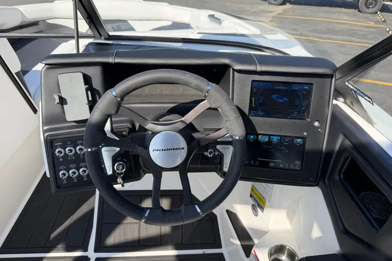 Slide: The Image of 2025 Moomba Makai boat dashboard with steering wheel and digital display. - 22
