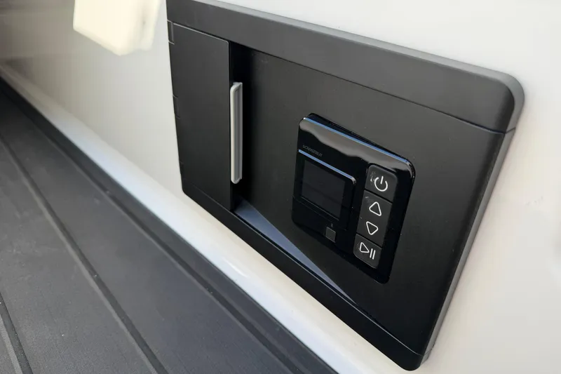 Slide: The Image of 2025 Moomba Makai control panel with sleek black design and intuitive buttons. - 26