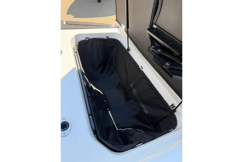 Slide: The Image of 2025 Moomba Makai boat storage compartment with black interior lining. - 27