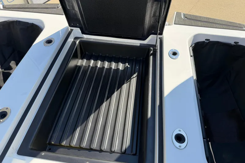 Slide: The Image of 2025 Moomba Makai boat storage compartment with open lid, showcasing interior space. - 28