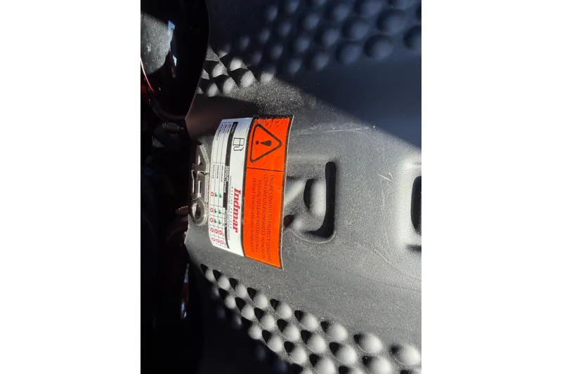 Slide: The Image of Close-up of a 2025 Moomba Makai engine warning label with textured surface. - 30