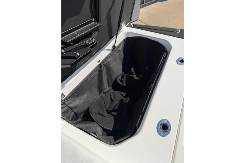 Slide: The Image of 2025 Moomba Makai boat storage compartment with open lid, showcasing interior space. - 31
