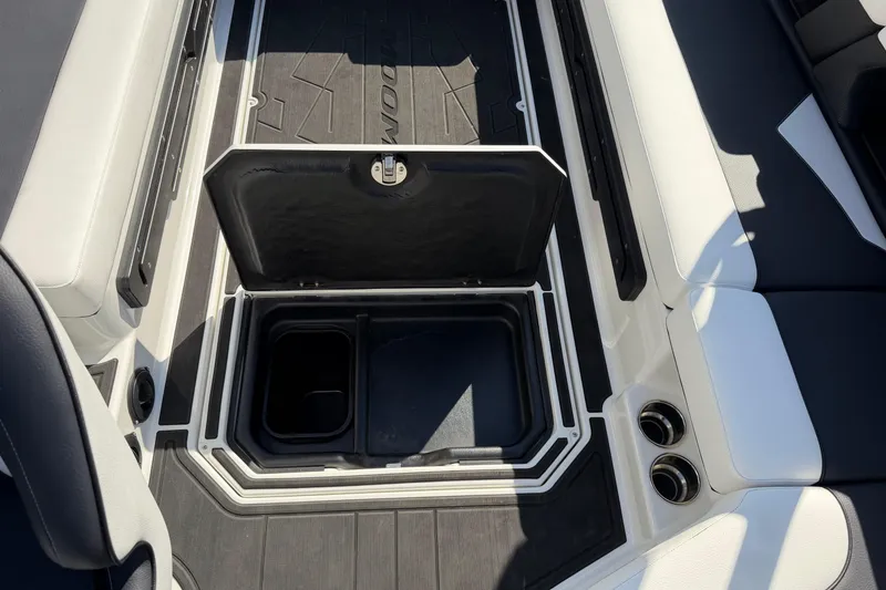 Slide: The Image of 2025 Moomba Makai boat interior storage compartment with open lid, showcasing sleek design. - 33
