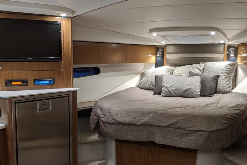 Slide: The Image of Luxurious cabin interior of 2019 Cruisers Yachts 38 Express with cozy bed and modern amenities. - 12