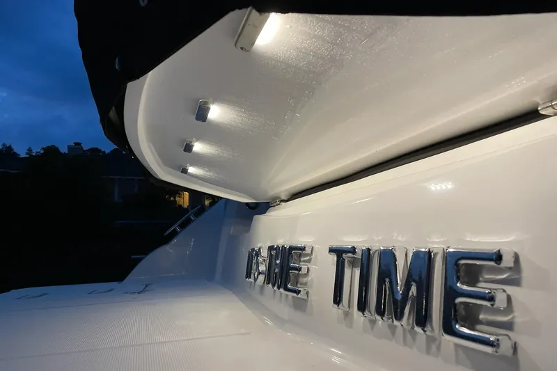 Slide: The Image of 2019 Cruisers Yachts 38 Express with illuminated nameplate at dusk. - 17
