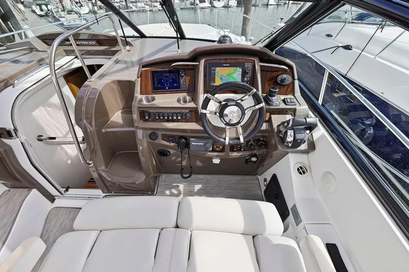 Slide: The Image of 2019 Cruisers Yachts 38 Express helm with navigation system and luxurious seating. - 18