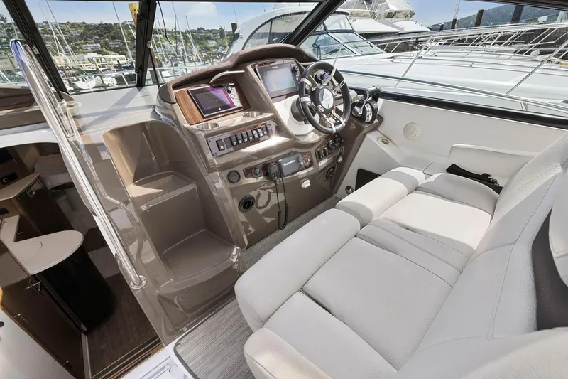 Slide: The Image of 2019 Cruisers Yachts 38 Express cockpit with modern controls and plush seating. - 19