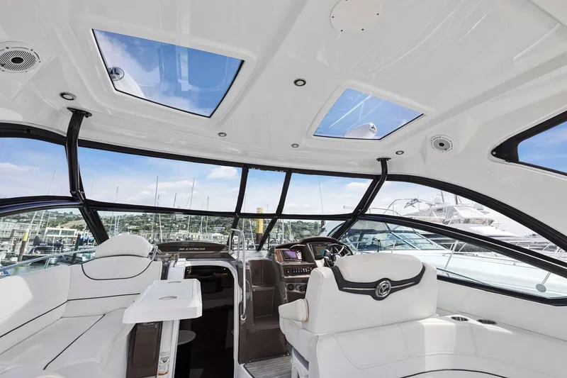 Slide: The Image of Interior of 2019 Cruisers Yachts 38 Express, featuring luxurious seating and panoramic windows. - 21