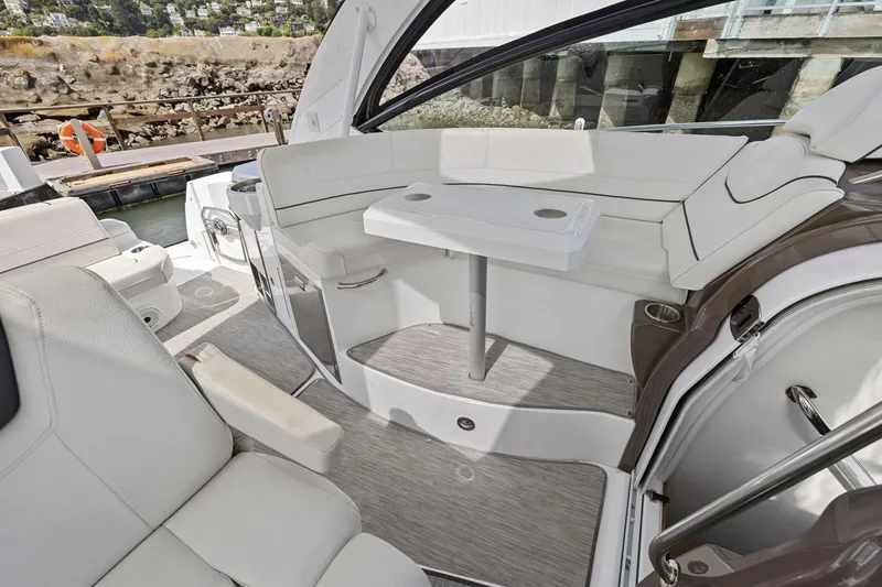 Slide: The Image of 2019 Cruisers Yachts 38 Express interior with elegant seating and table setup. - 23