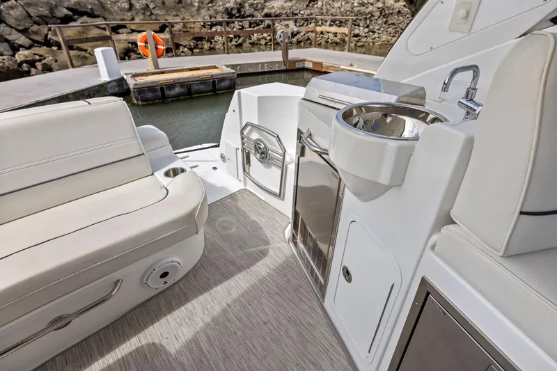 Slide: The Image of 2019 Cruisers Yachts 38 Express interior with seating and kitchenette. - 24