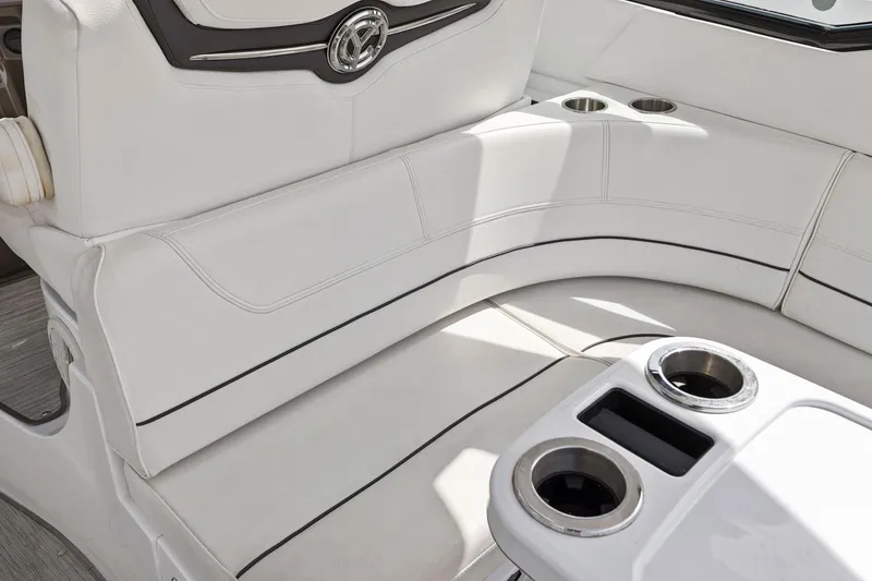 Slide: The Image of 2019 Cruisers Yachts 38 Express interior seating with cup holders, featuring elegant white upholstery. - 26