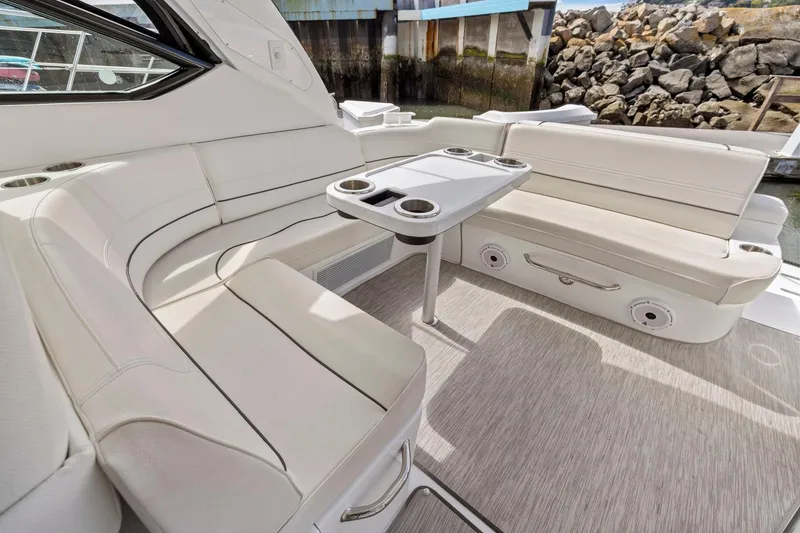 Slide: The Image of Luxurious seating area on 2019 Cruisers Yachts 38 Express with table and cup holders. - 28