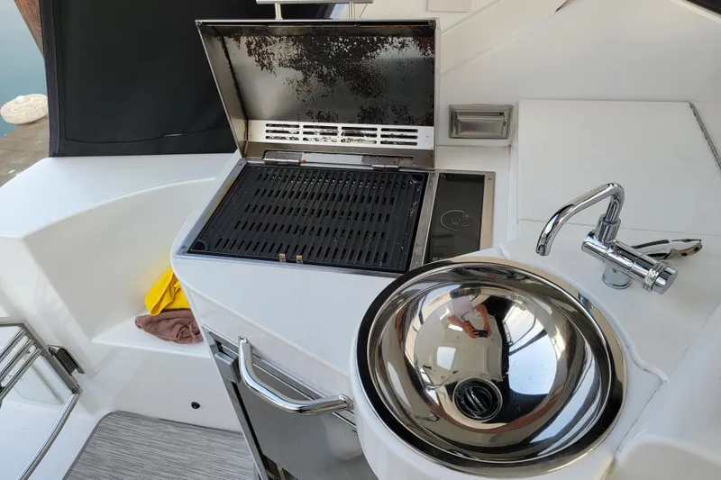 Slide: The Image of Outdoor kitchen on 2019 Cruisers Yachts 38 Express with grill and sink. - 29