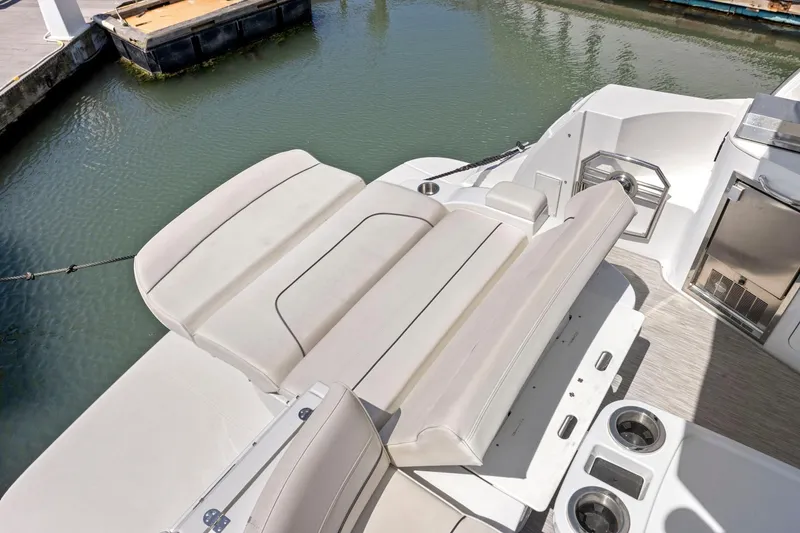 Slide: The Image of 2019 Cruisers Yachts 38 Express boat interior with seating and cup holders. - 33