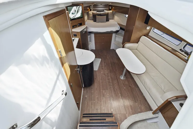 Slide: The Image of 2019 Cruisers Yachts 38 Express interior with modern furnishings and cozy sleeping area. - 36