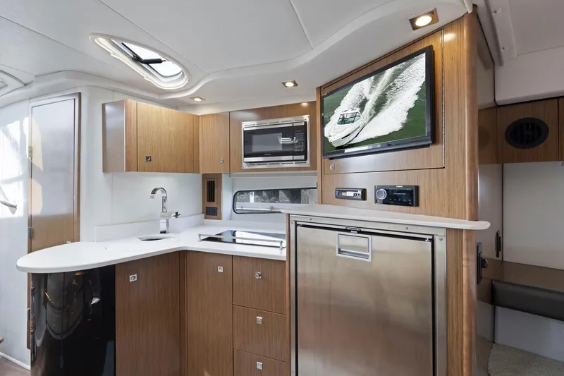Slide: The Image of Luxurious interior of 2019 Cruisers Yachts 38 Express with modern kitchen amenities. - 39