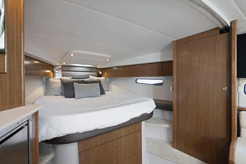 Slide: The Image of Luxurious interior cabin of 2019 Cruisers Yachts 38 Express with elegant wood finishes. - 40