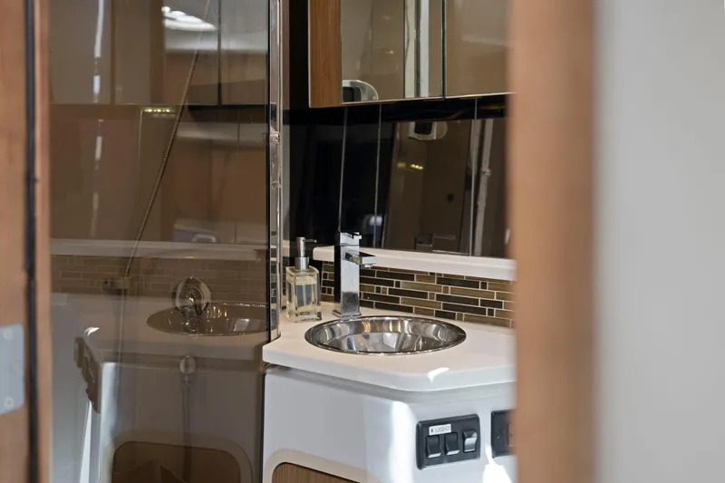 Slide: The Image of Luxurious bathroom interior of 2019 Cruisers Yachts 38 Express with modern sink and fixtures. - 43