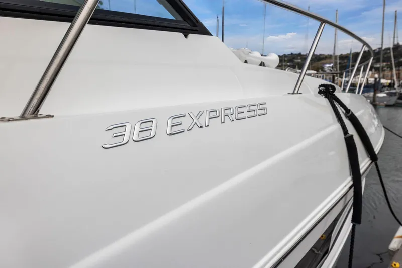 Slide: The Image of 2019 Cruisers Yachts 38 Express boat docked, showcasing sleek design and branding. - 45