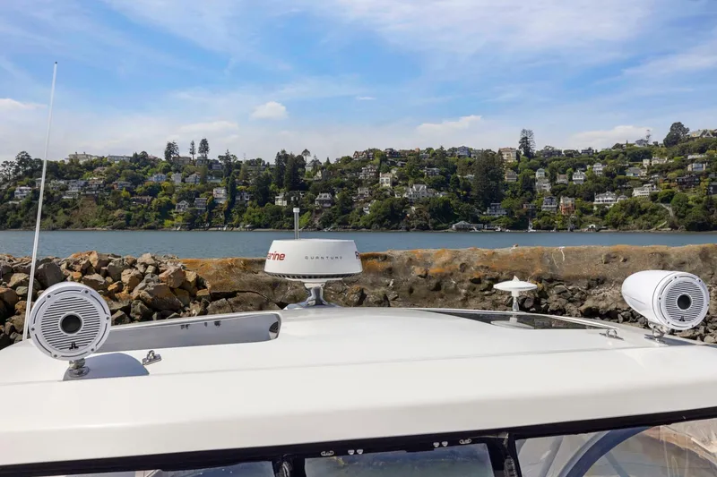 Slide: The Image of 2019 Cruisers Yachts 38 Express with scenic waterfront view and hillside homes. - 47