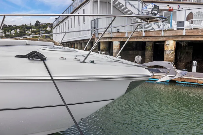 Slide: The Image of 2019 Cruisers Yachts 38 Express docked at marina, showcasing sleek design and anchor. - 49