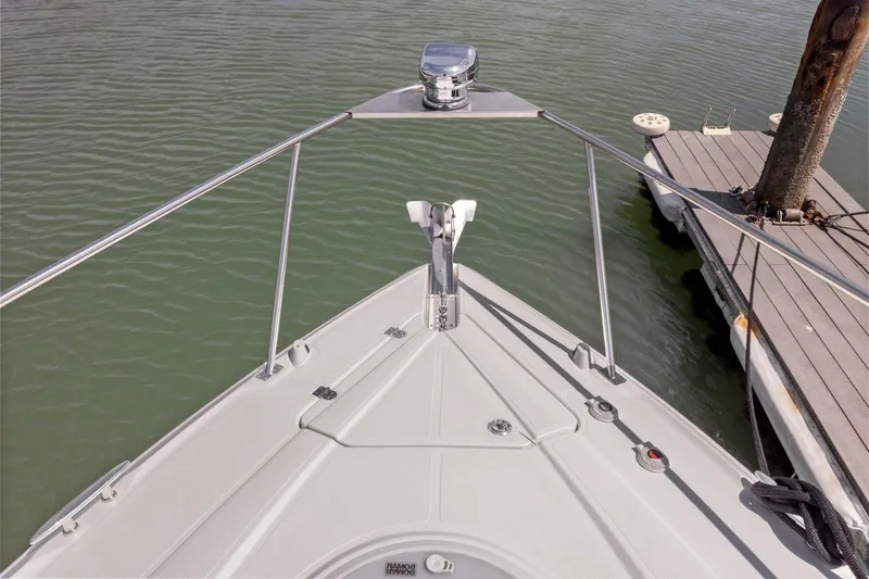 Slide: The Image of Bow view of 2019 Cruisers Yachts 38 Express docked on calm water. - 50