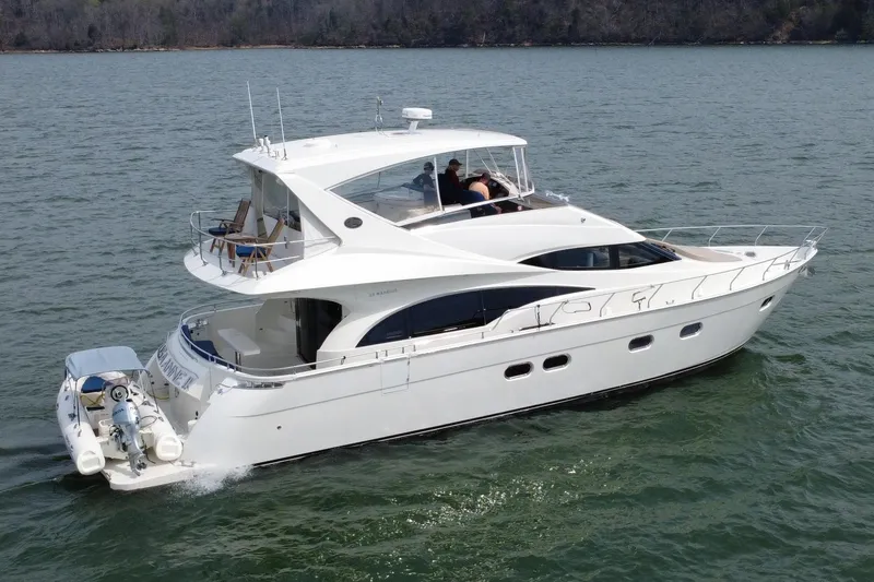 Slide: The Image of 2004 Marquis 59 luxury yacht cruising on calm waters. - 11