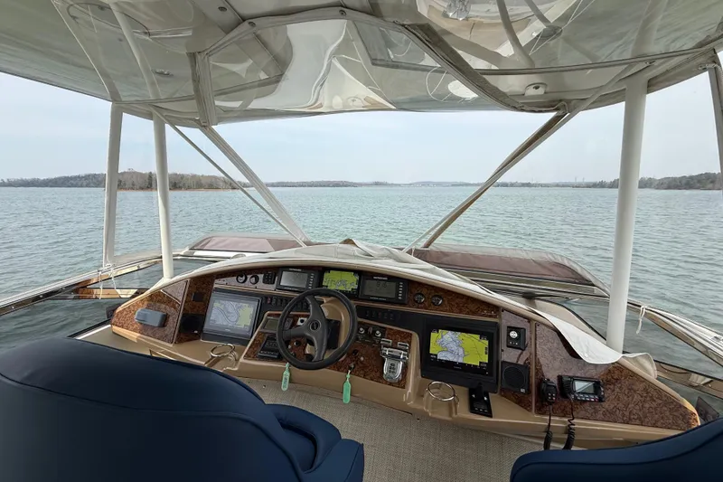Slide: The Image of Interior view of a 2004 Marquis 59 yacht cockpit with navigation equipment. - 15