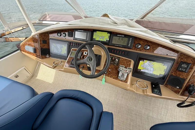 Slide: The Image of Helm of 2004 Marquis 59 yacht with navigation screens and controls. - 17