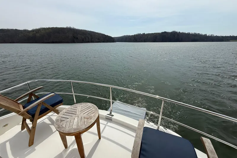 Slide: The Image of Luxury yacht Marquis 59, 2004 model, with scenic lake view and comfortable deck seating. - 18