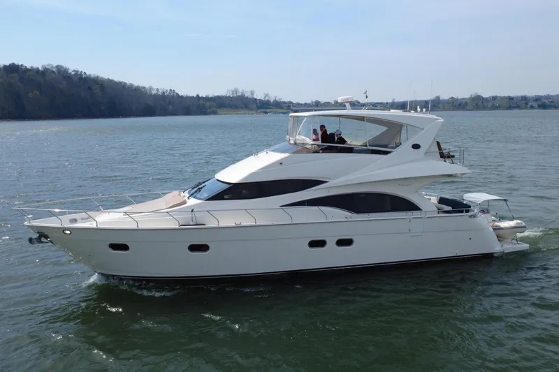 Slide: The Image of 2004 Marquis 59 luxury yacht cruising on calm waters. - 2