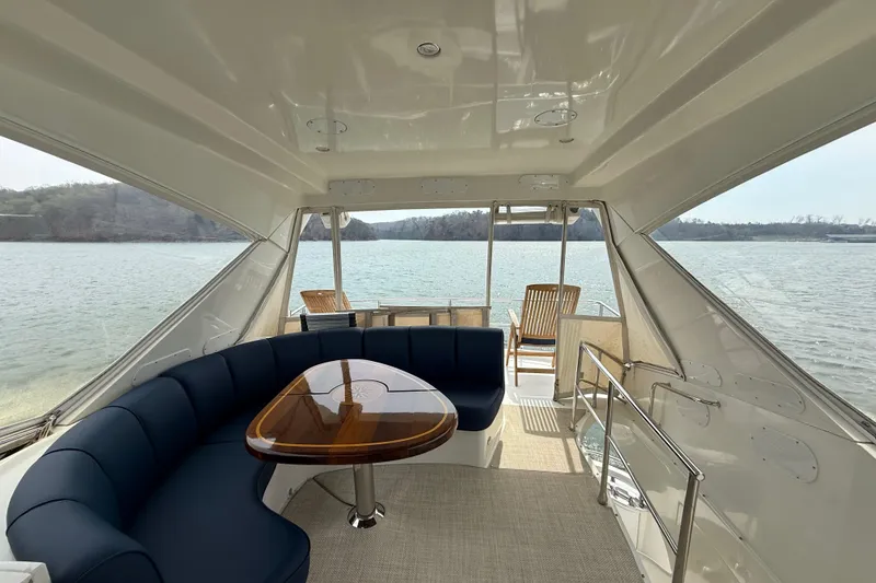 Slide: The Image of Luxurious 2004 Marquis 59 yacht interior with elegant seating and scenic water view. - 20