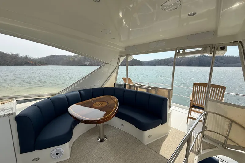 Slide: The Image of Luxurious 2004 Marquis 59 yacht interior with elegant seating and scenic water view. - 21