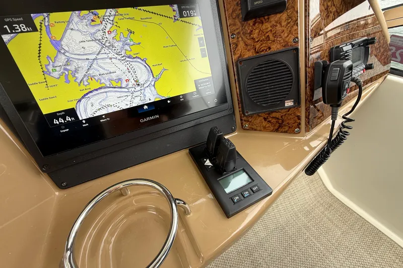 Slide: The Image of Boat dashboard with Garmin GPS, radio, and controls on a 2004 Marquis 59. - 23